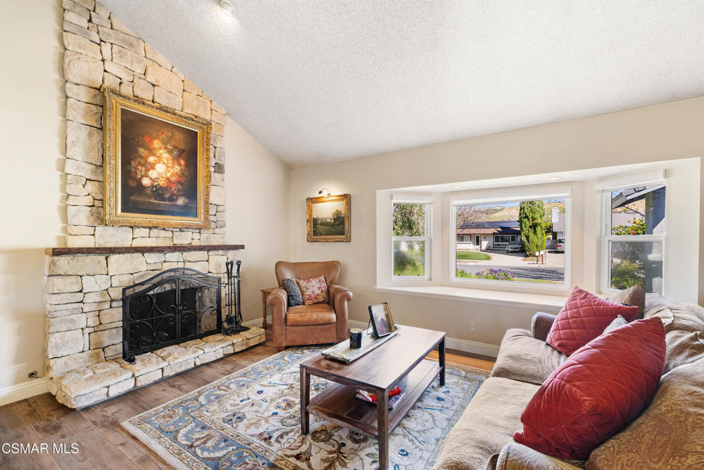 5914 Cochran Street Simi Valley, CA 93063 - Photo 6 of 23 a living room with furniture a fireplace and a large window