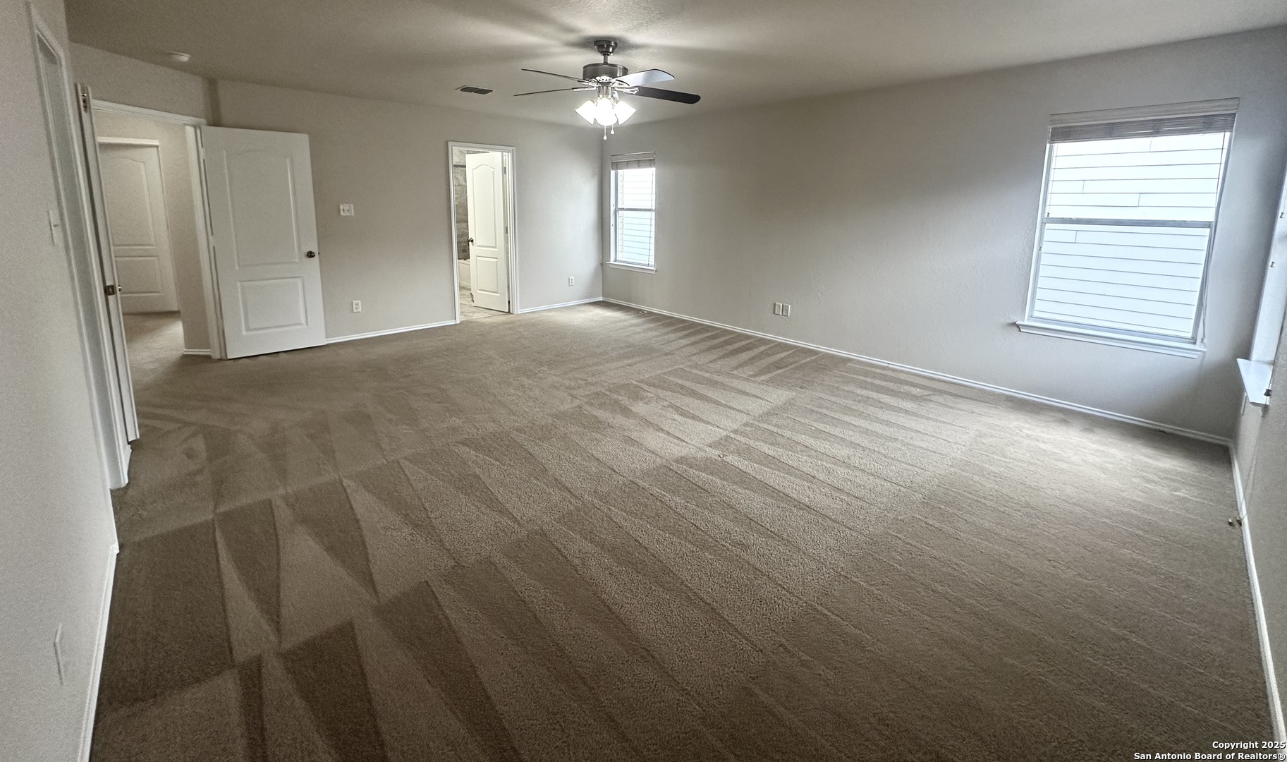 6741 Wayman Ridge Live Oak, TX 78233 - Photo 11 of 25 an empty room with windows and fan