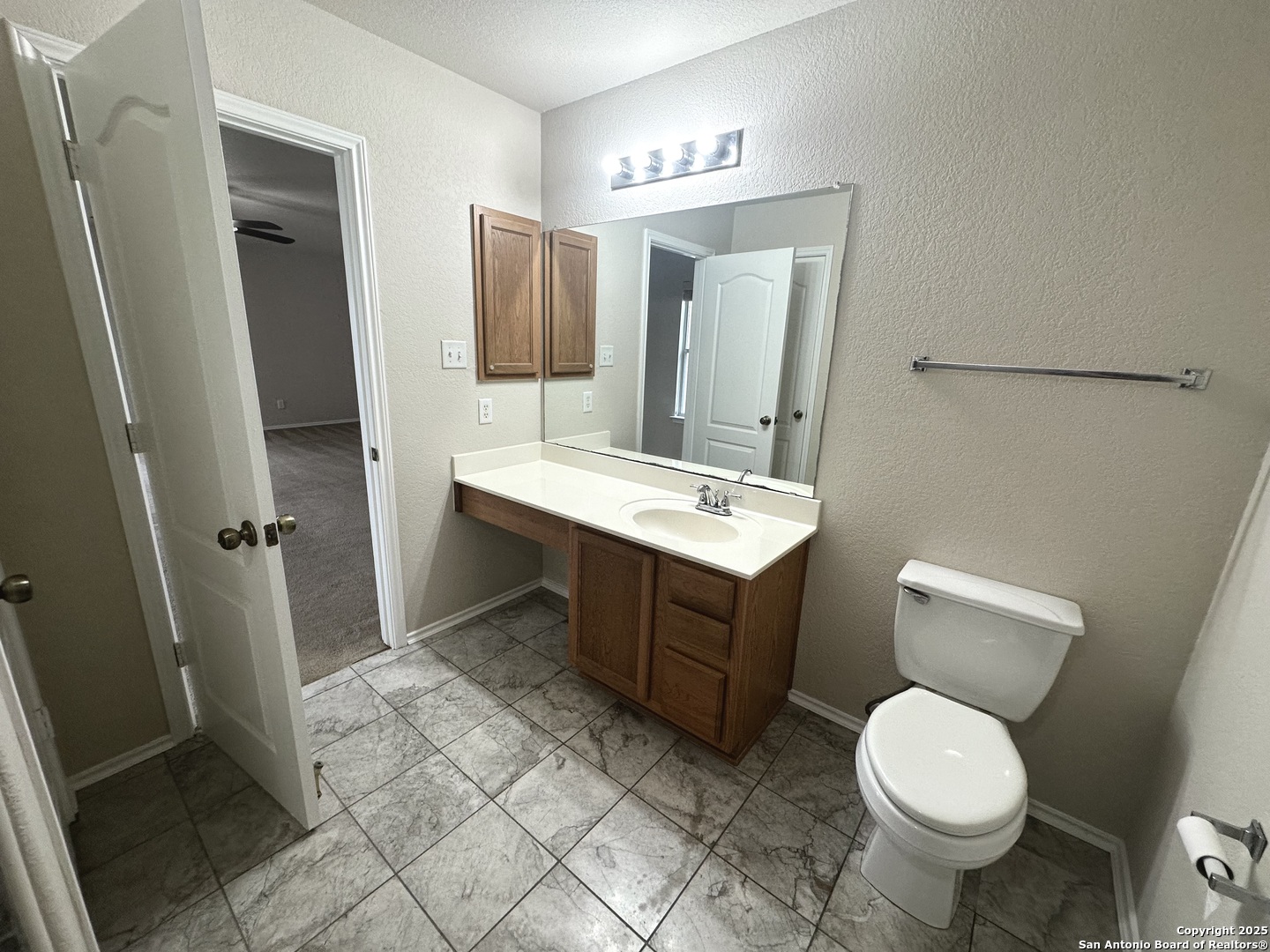 6741 Wayman Ridge Live Oak, TX 78233 - Photo 13 of 25 a bathroom with a toilet sink and mirror