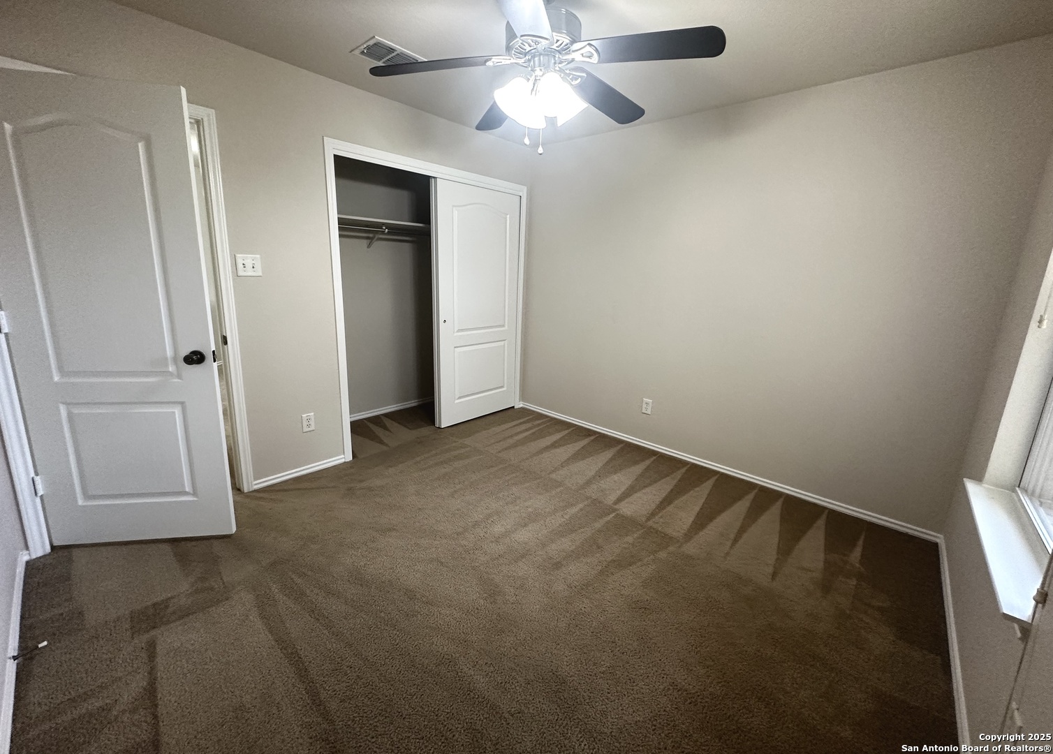 6741 Wayman Ridge Live Oak, TX 78233 - Photo 17 of 25 an empty room with closet and a chandelier fan