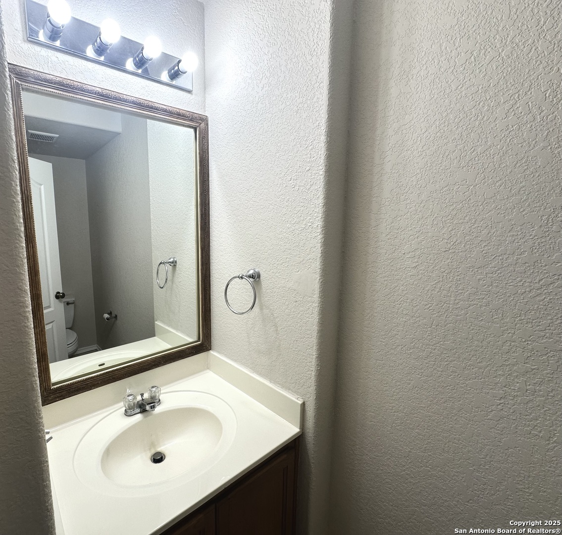 6741 Wayman Ridge Live Oak, TX 78233 - Photo 24 of 25 a bathroom with a sink and a mirror