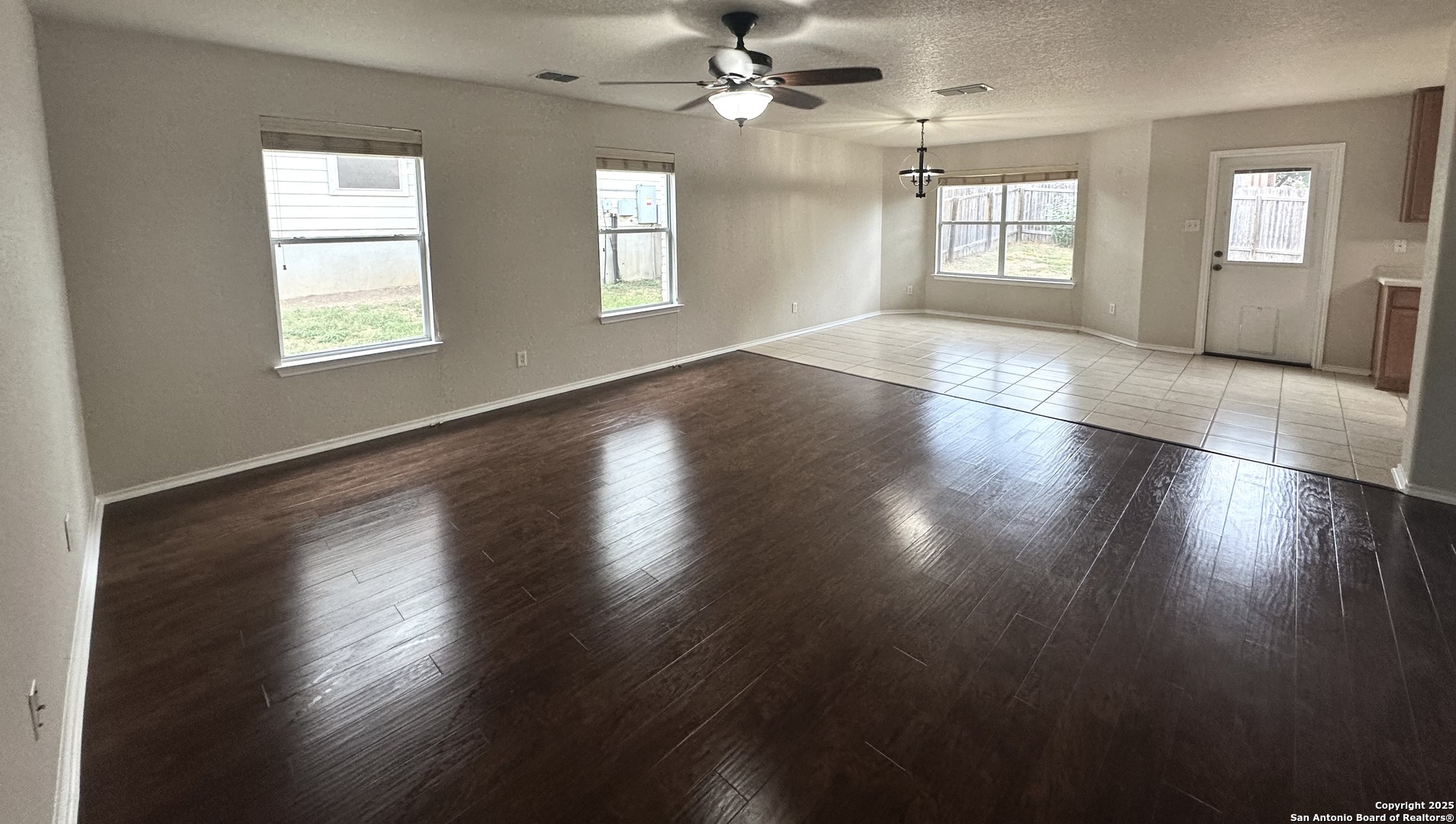 6741 Wayman Ridge Live Oak, TX 78233 - Photo 5 of 25 a view of an empty room with wooden floor and a window