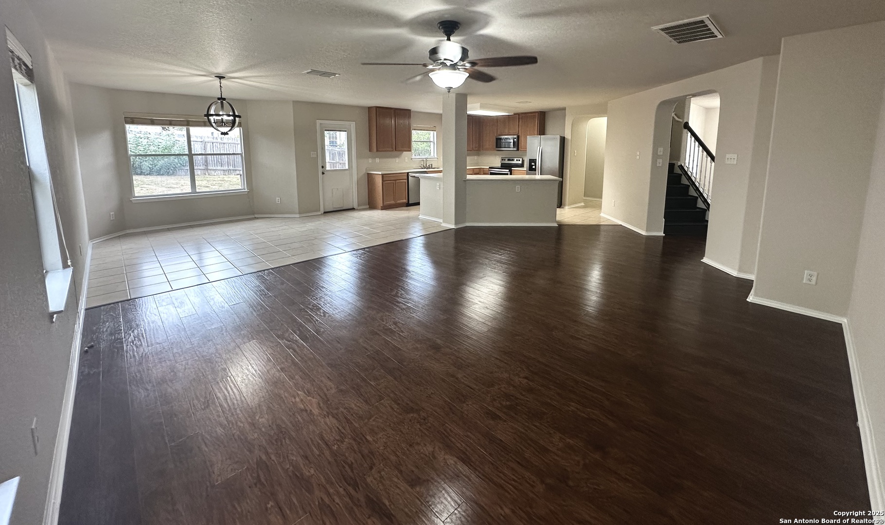 6741 Wayman Ridge Live Oak, TX 78233 - Photo 6 of 25 an empty room with wooden floor fireplace and windows
