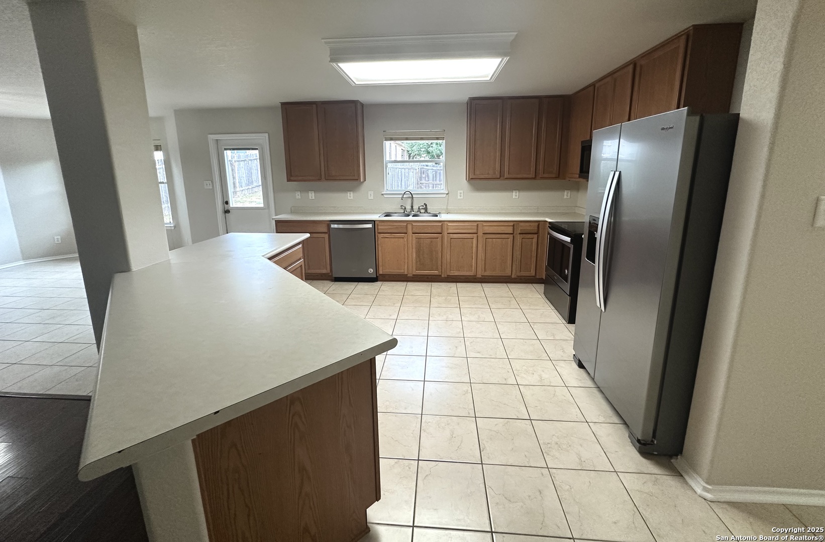 6741 Wayman Ridge Live Oak, TX 78233 - Photo 7 of 25 a kitchen with stainless steel appliances a refrigerator and a sink
