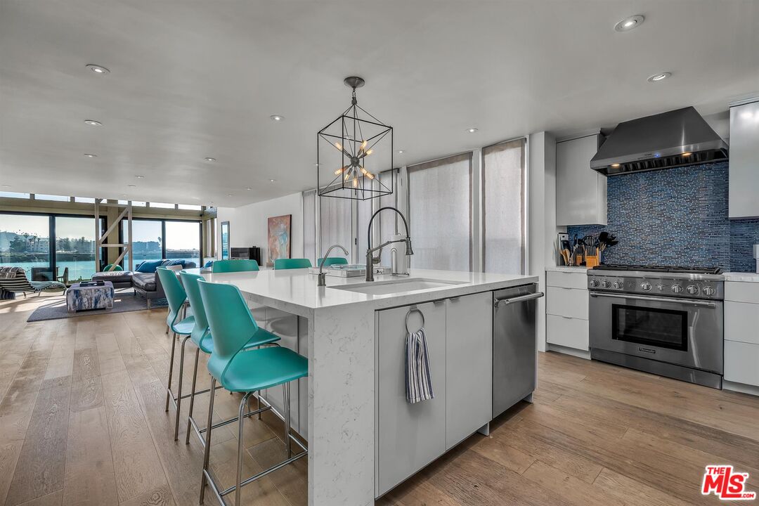 5515 Pacific Avenue, Unit 1 Marina del Rey, CA 90292 - Photo 19 of 45 a kitchen with granite countertop a stove a sink and a wooden floors
