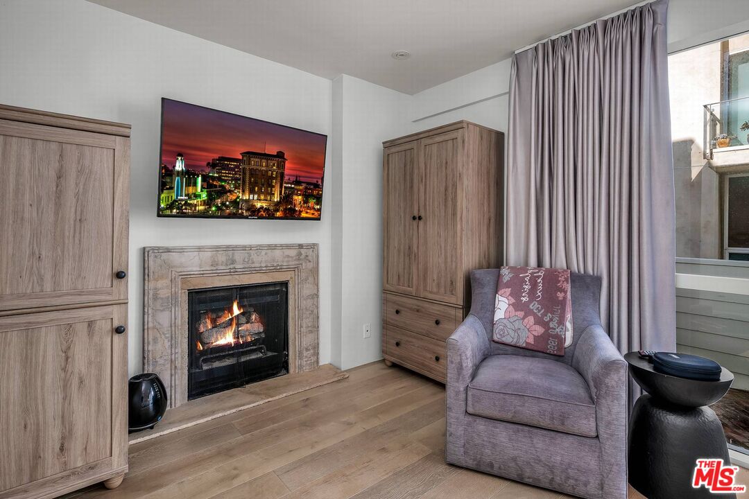 5515 Pacific Avenue, Unit 1 Marina del Rey, CA 90292 - Photo 25 of 45 a living room with furniture a flat screen tv and a fireplace