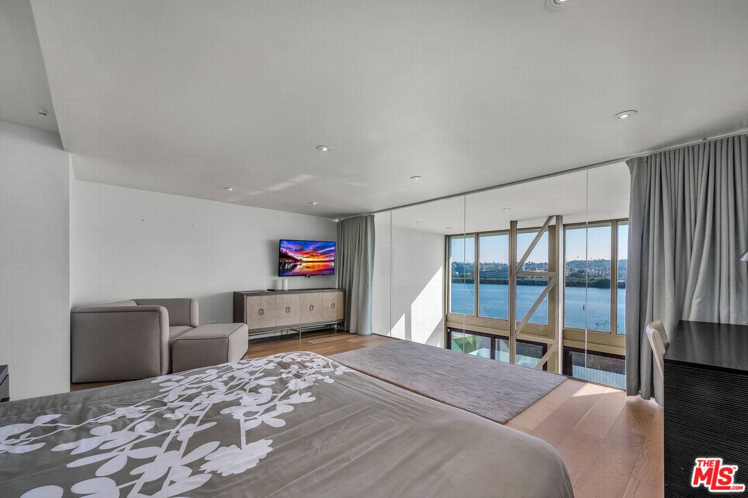 5515 Pacific Avenue, Unit 1 Marina del Rey, CA 90292 - Photo 30 of 45 a bedroom with a bed and a large window with outer view