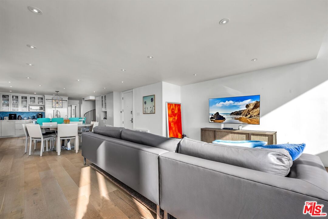 5515 Pacific Avenue, Unit 1 Marina del Rey, CA 90292 - Photo 9 of 45 a living room with furniture and a dining table with kitchen appliances