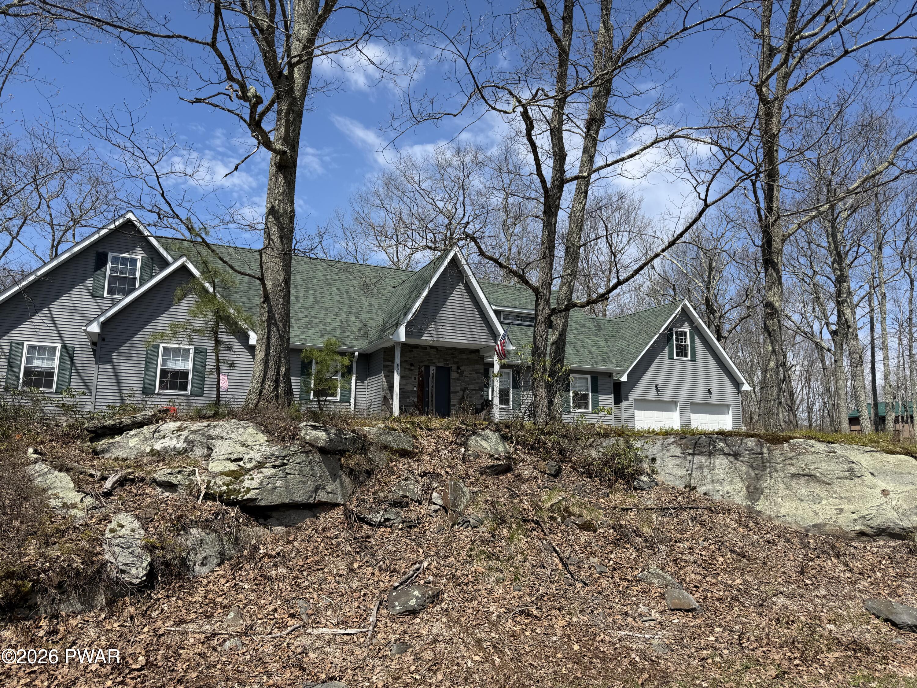 801 Maple Ridge Court Hawley, PA 18428 - Photo 3 of 55 a front view of a house with a yard