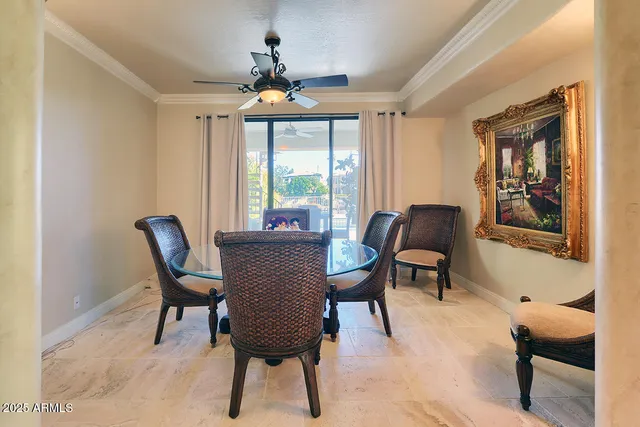 an outdoor sitting area with furniture and lake view