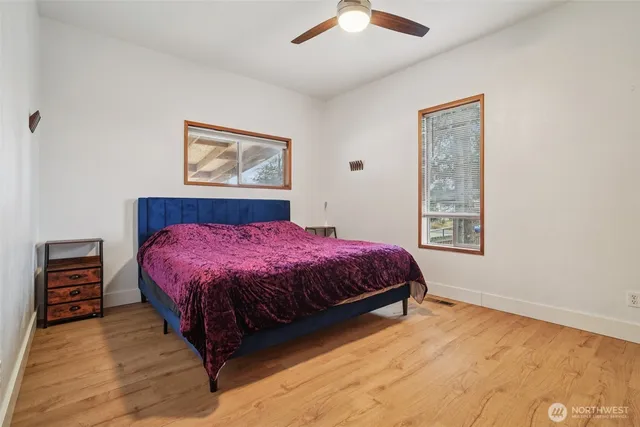 a spacious bedroom with a bed and a window