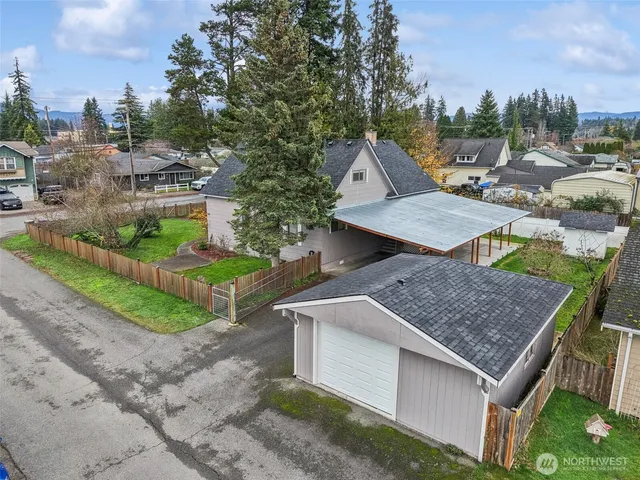 an aerial view of a house with garden space and houses