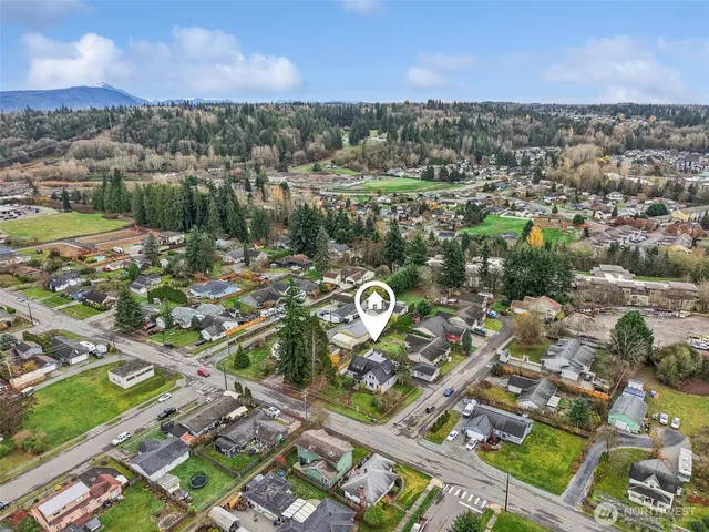 an aerial view of residential houses with outdoor space and river