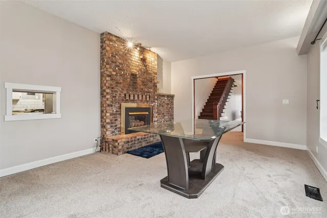 a living room with furniture a fireplace and a painting