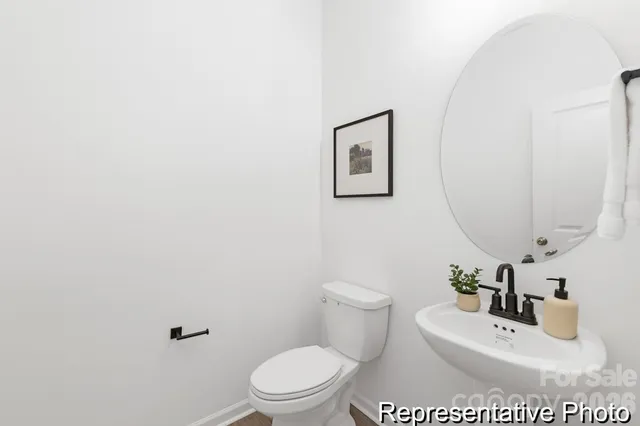 a white toilet sitting next to a bathroom sink