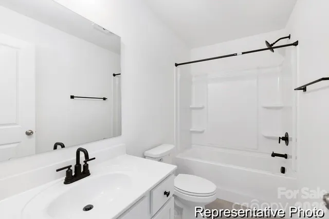 a bathroom with a sink a toilet a mirror a bathtub and shower