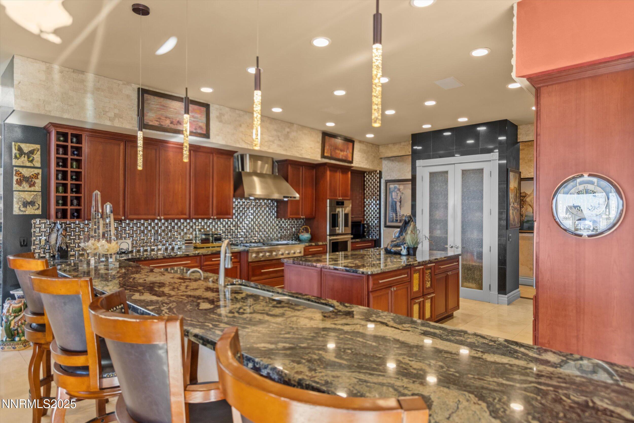 10411 Copper Cloud Drive Reno, NV 89511 - Photo 11 of 54 a large kitchen with stainless steel appliances lots of counter top space