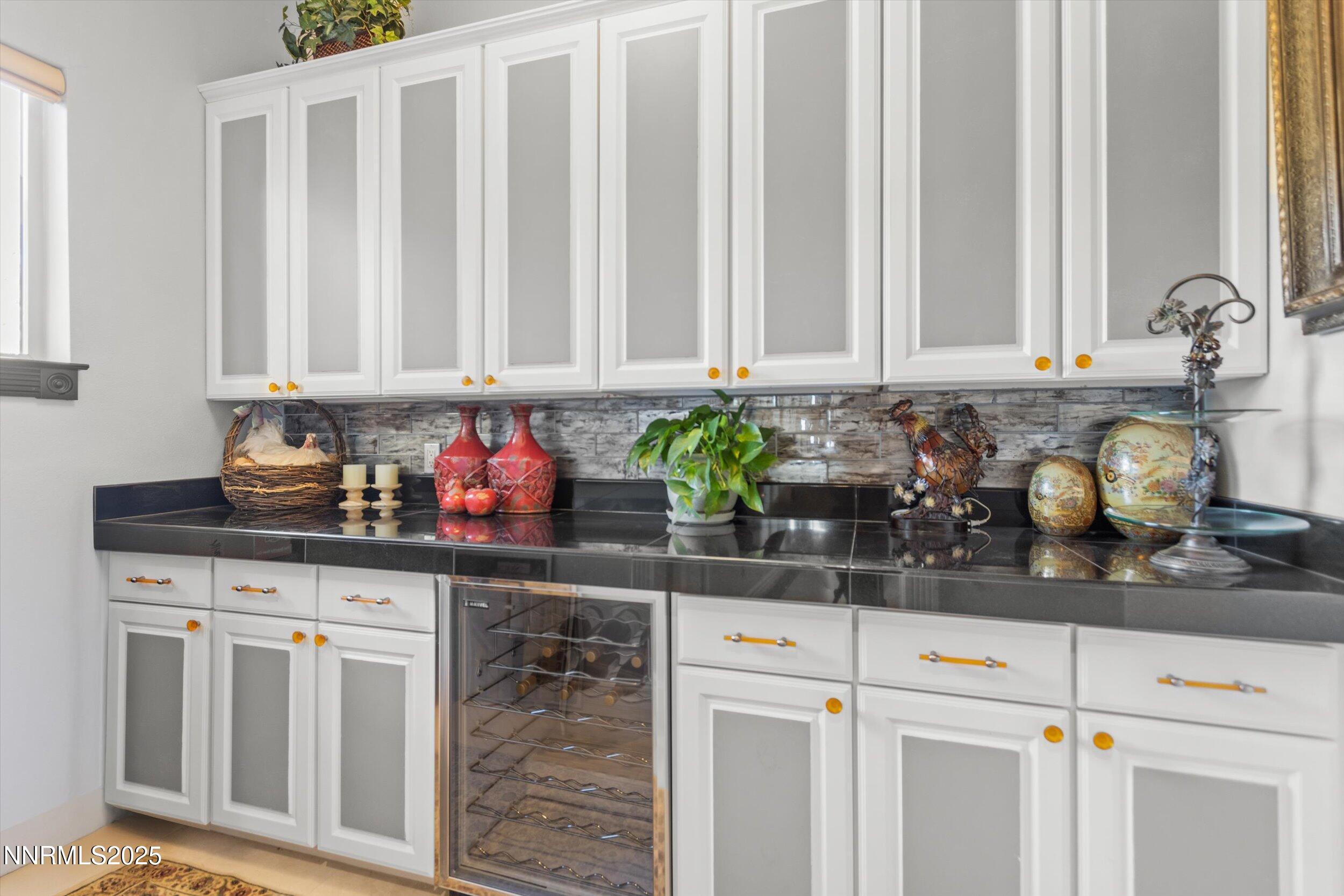 10411 Copper Cloud Drive Reno, NV 89511 - Photo 13 of 54 a kitchen with granite countertop a sink white cabinets and a window