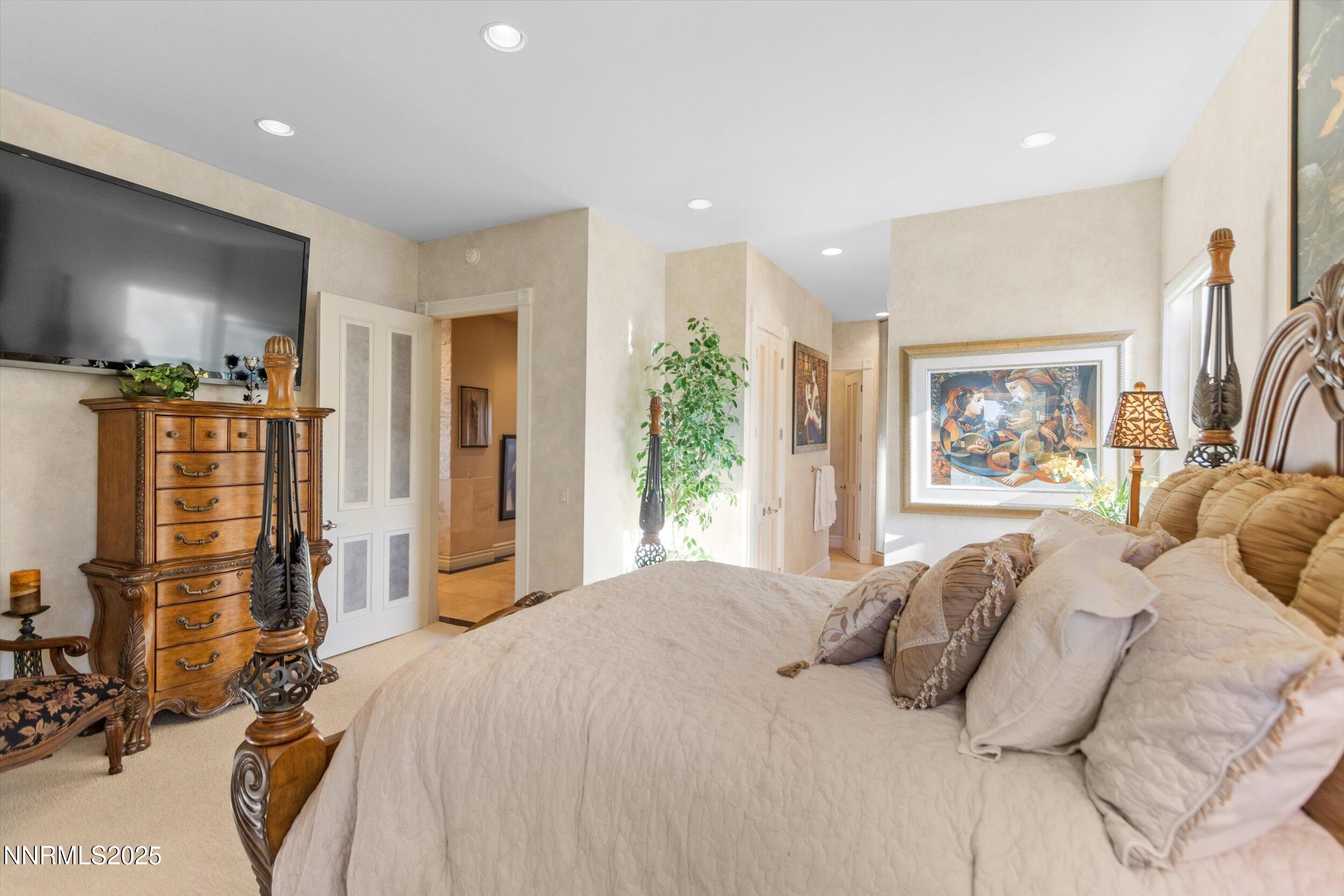 10411 Copper Cloud Drive Reno, NV 89511 - Photo 20 of 54 a bedroom with furniture and a flat screen tv
