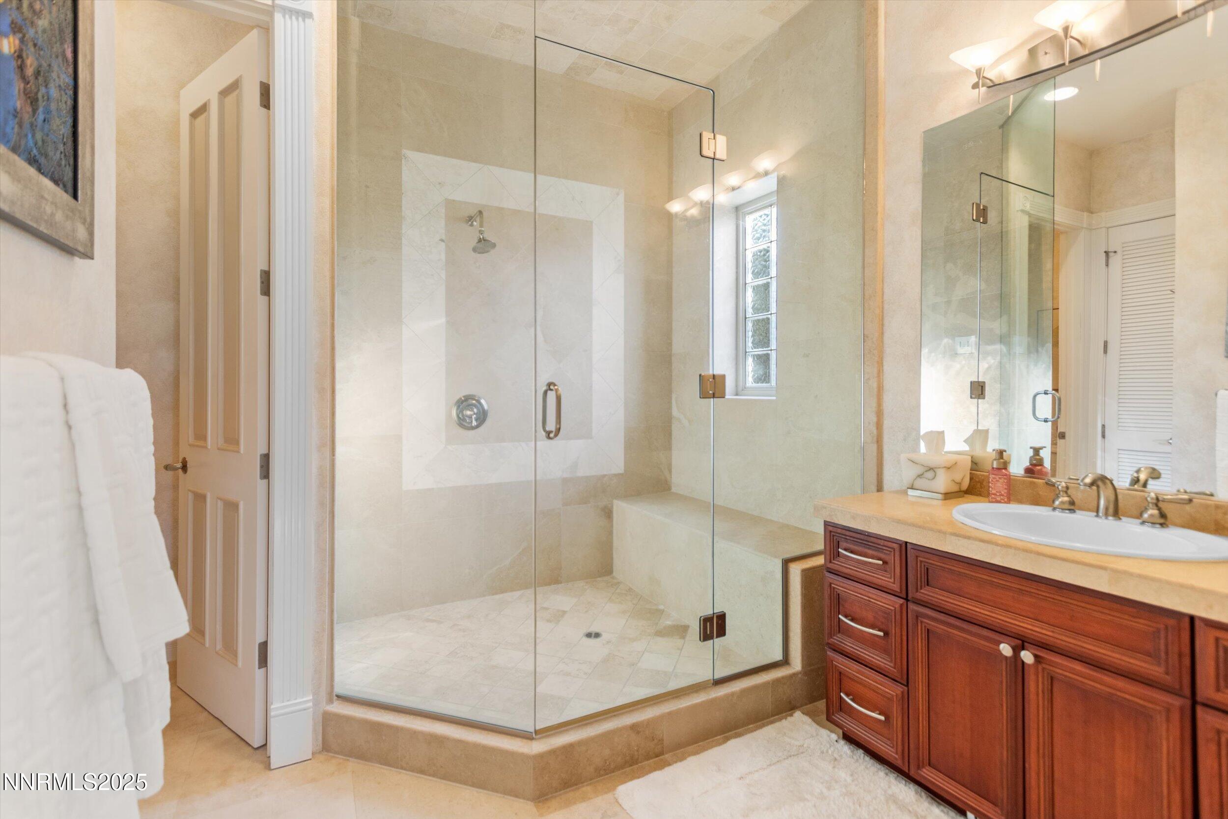10411 Copper Cloud Drive Reno, NV 89511 - Photo 21 of 54 a bathroom with a double vanity sink mirror and shower