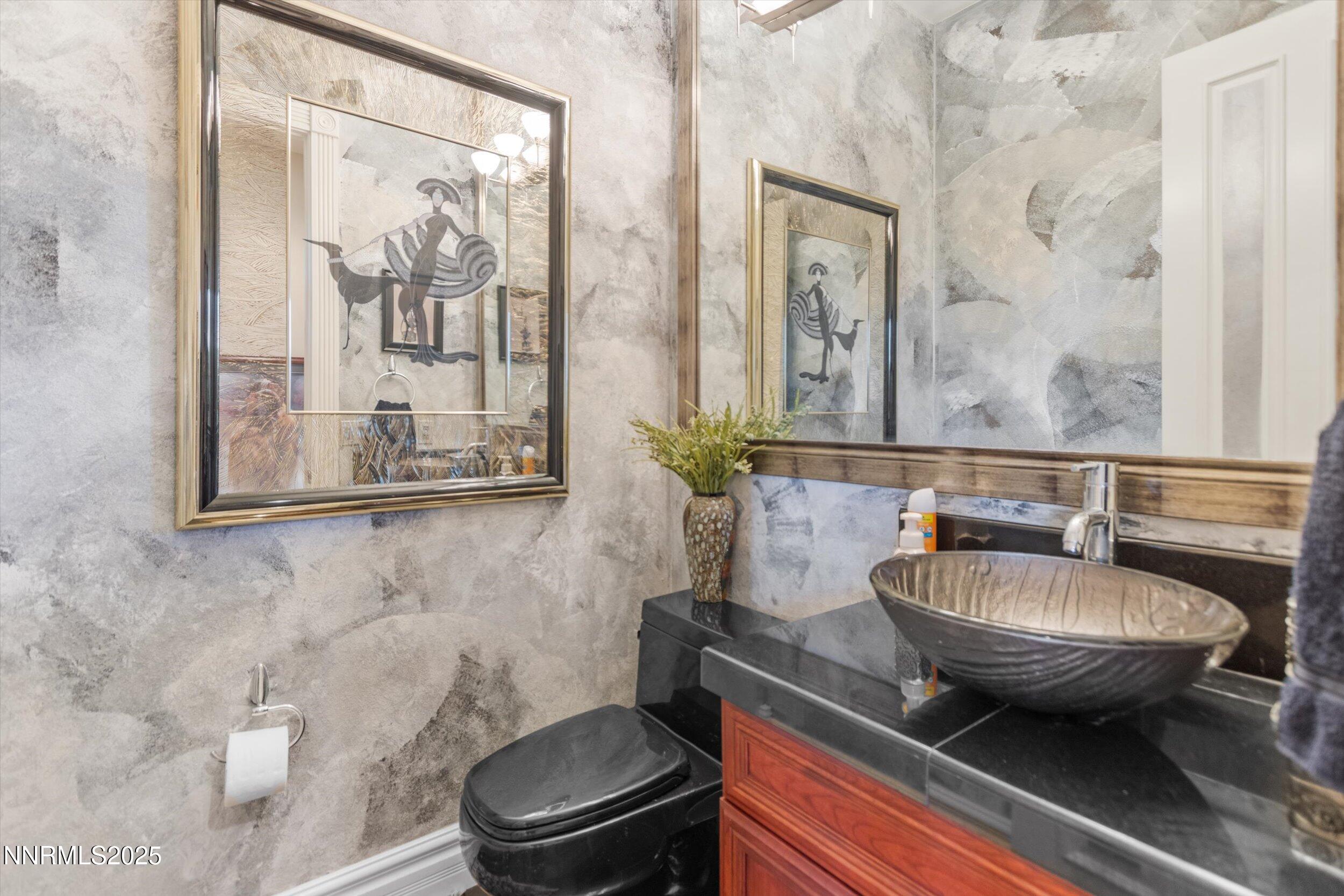 10411 Copper Cloud Drive Reno, NV 89511 - Photo 22 of 54 a bathroom with a toilet a sink and mirror