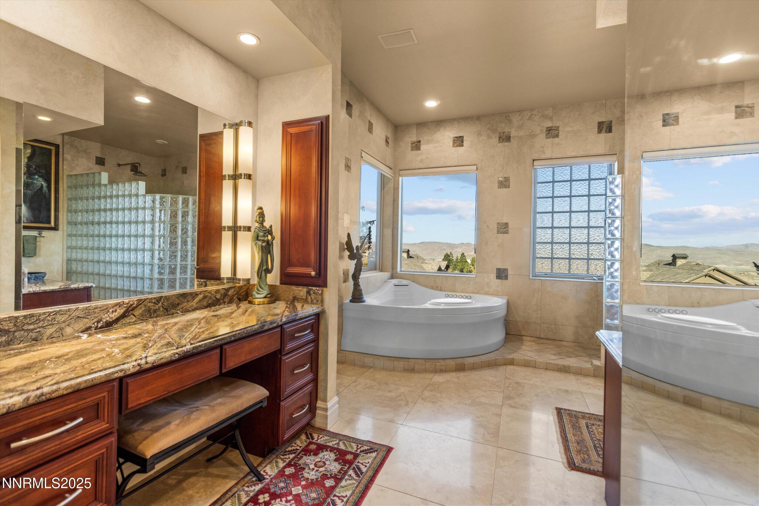 10411 Copper Cloud Drive Reno, NV 89511 - Photo 30 of 54 a spacious bathroom with a granite countertop tub sink and mirror