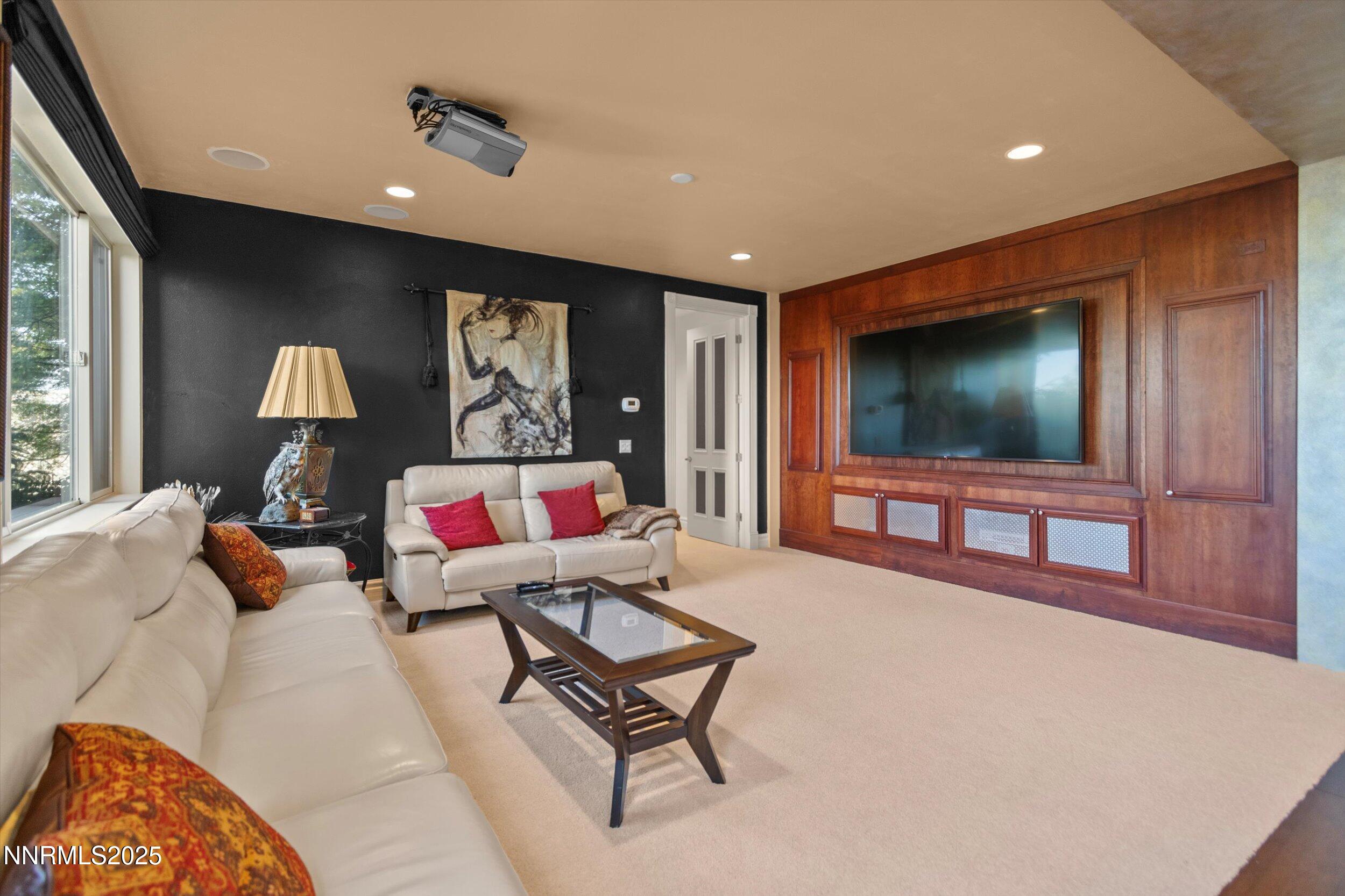 10411 Copper Cloud Drive Reno, NV 89511 - Photo 31 of 54 a living room with furniture and a flat screen tv