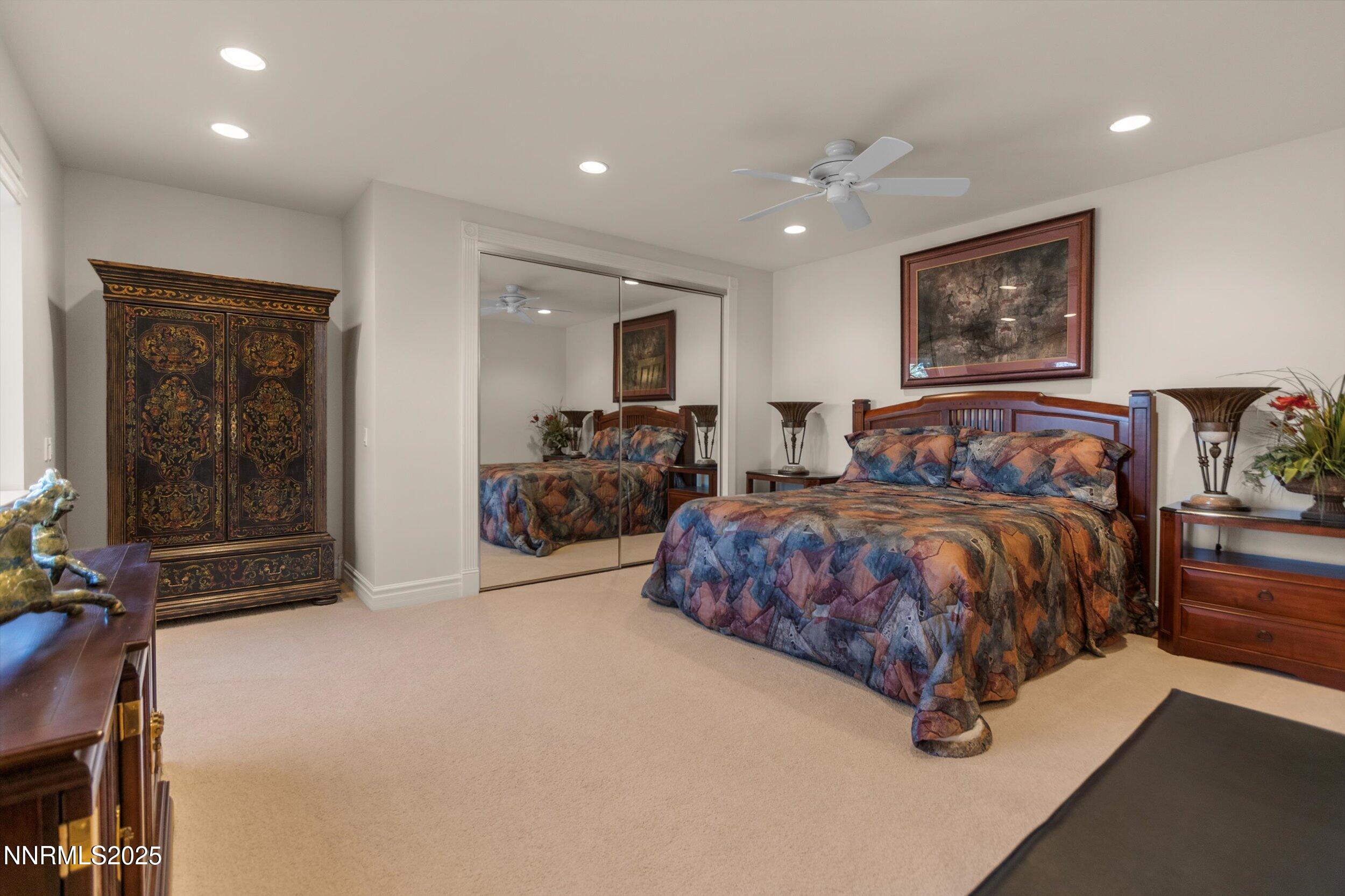 10411 Copper Cloud Drive Reno, NV 89511 - Photo 35 of 54 a spacious bedroom with a bed and glass window