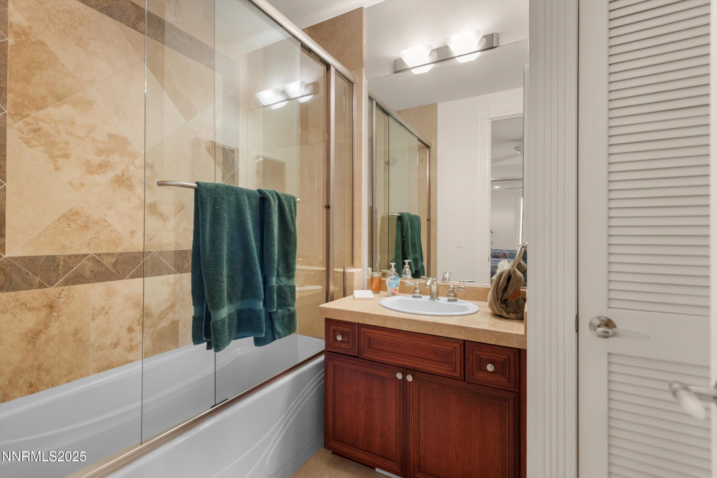 10411 Copper Cloud Drive Reno, NV 89511 - Photo 36 of 54 a bathroom with a double vanity sink and mirror