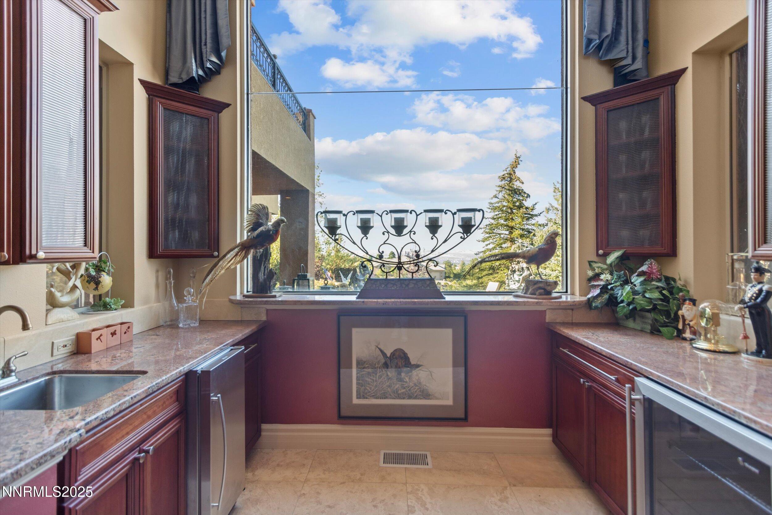 10411 Copper Cloud Drive Reno, NV 89511 - Photo 37 of 54 a kitchen with stainless steel appliances granite countertop a sink and a wooden floor