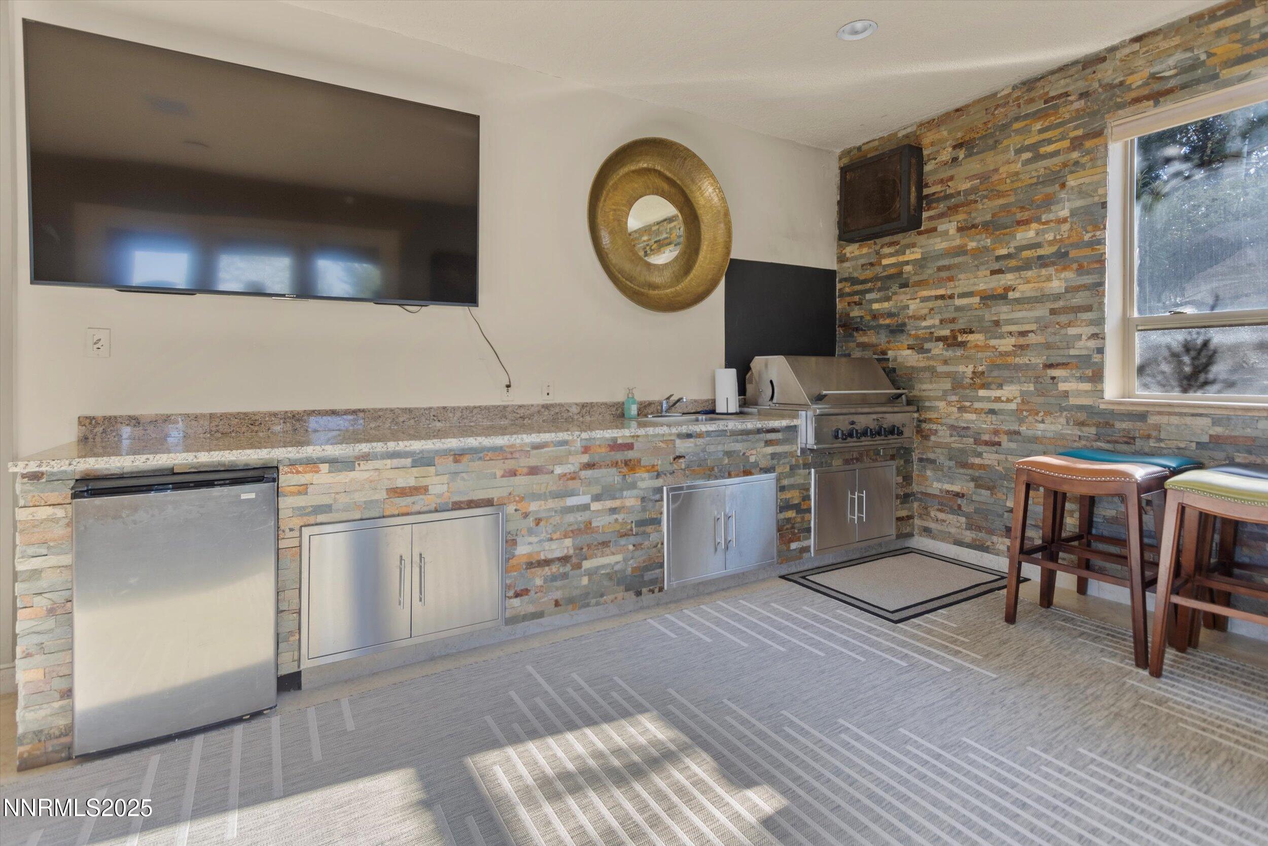 10411 Copper Cloud Drive Reno, NV 89511 - Photo 41 of 54 a kitchen with stainless steel appliances granite countertop a stove a sink and a microwave