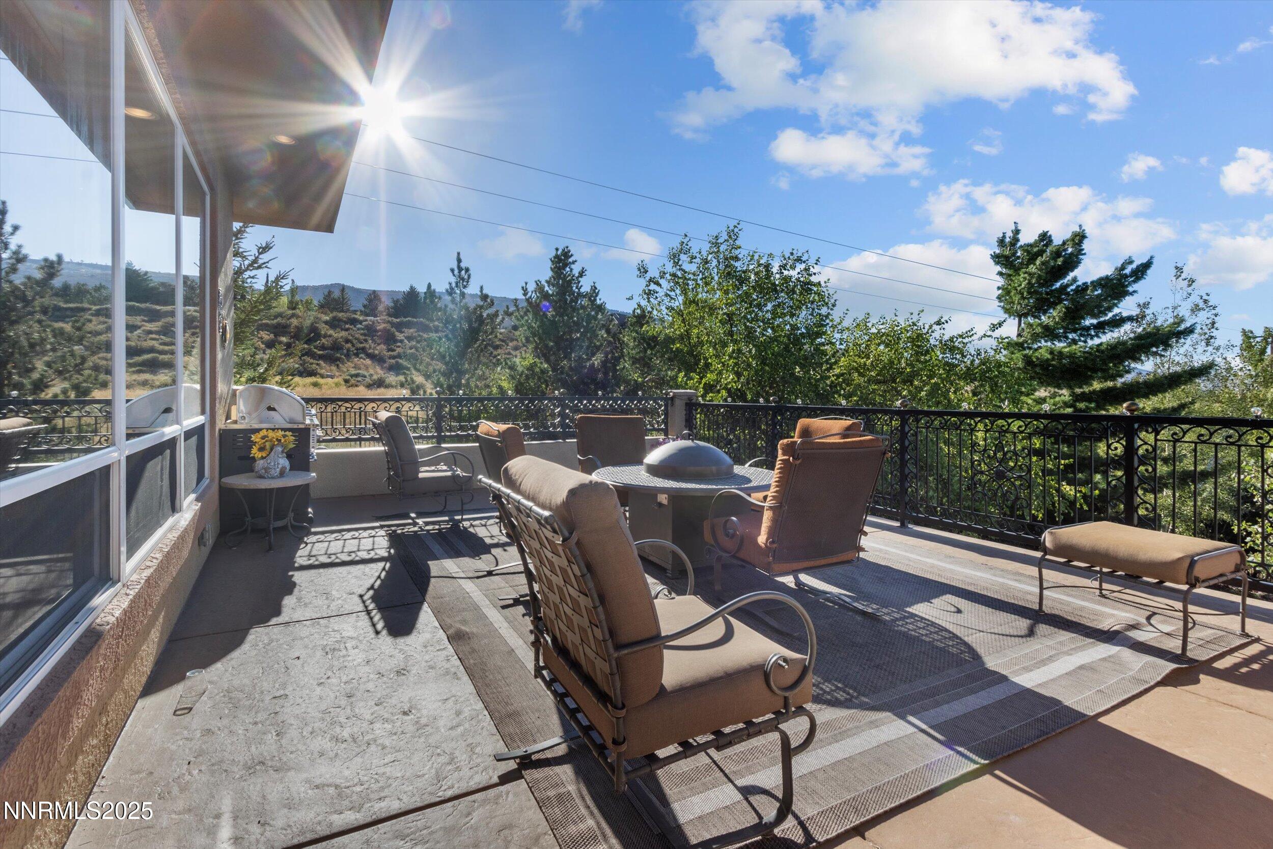 10411 Copper Cloud Drive Reno, NV 89511 - Photo 42 of 54 a roof deck with table and chairs and potted plants