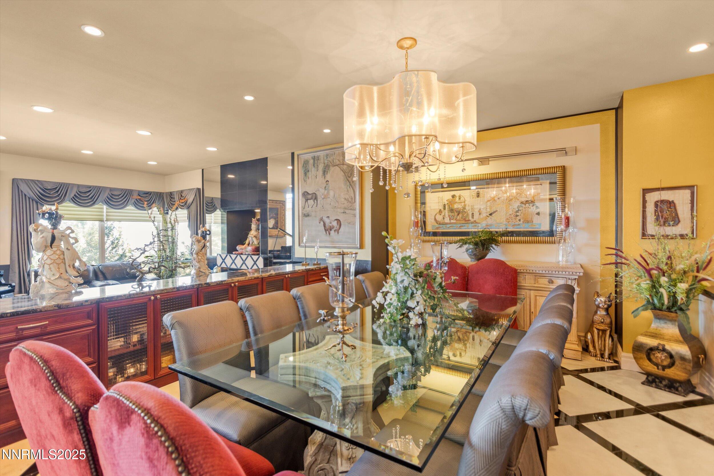 10411 Copper Cloud Drive Reno, NV 89511 - Photo 6 of 54 a view of a dining room with furniture a chandelier and wooden floor