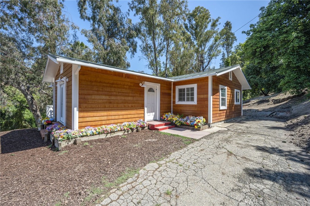 411 E Road La Habra Heights, CA 90631 - Photo 1 of 1 a view of a house with a yard and garage