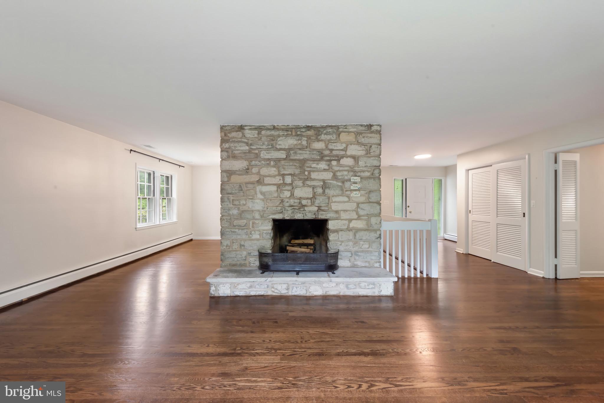 13409 Cambria Farms Road Phoenix, MD 21131 - Photo 11 of 54 a living room with hard wood floors and a fireplace