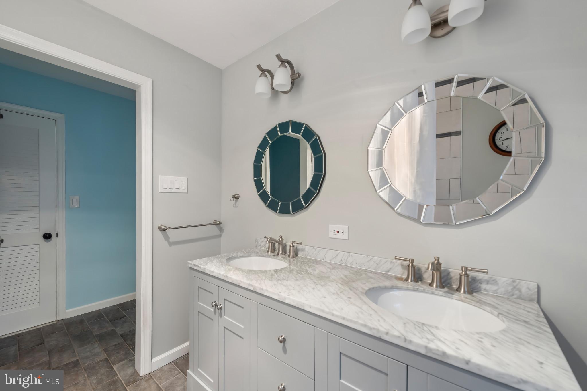 13409 Cambria Farms Road Phoenix, MD 21131 - Photo 24 of 54 a bathroom with a granite countertop double vanity sink and mirror