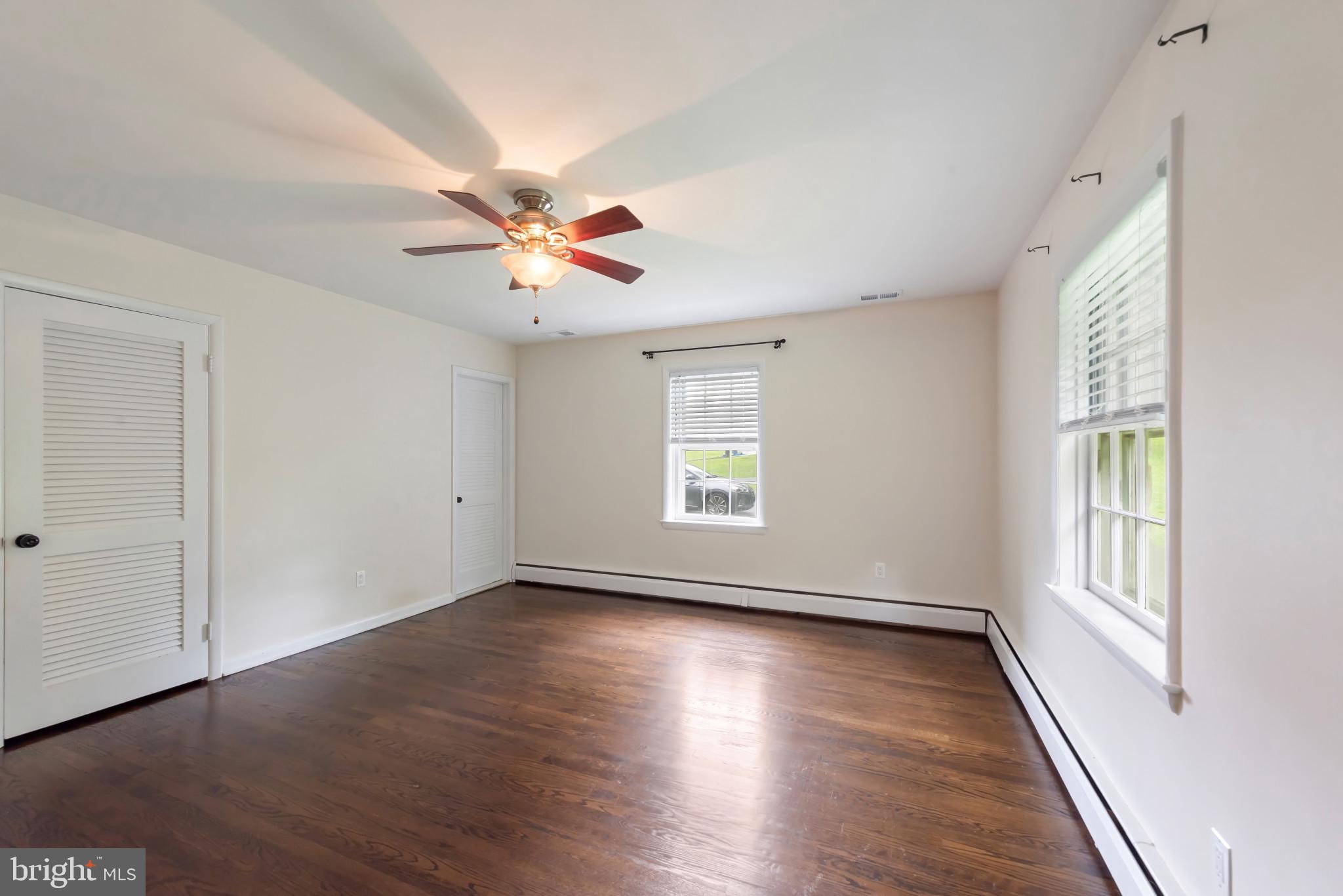 13409 Cambria Farms Road Phoenix, MD 21131 - Photo 26 of 54 an empty room with wooden floor and windows