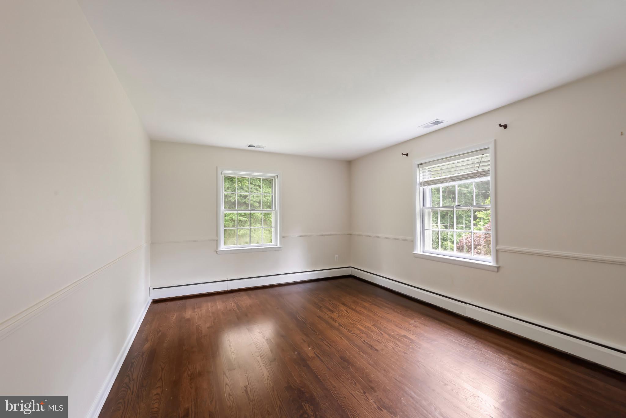 13409 Cambria Farms Road Phoenix, MD 21131 - Photo 28 of 54 an empty room with wooden floor and windows
