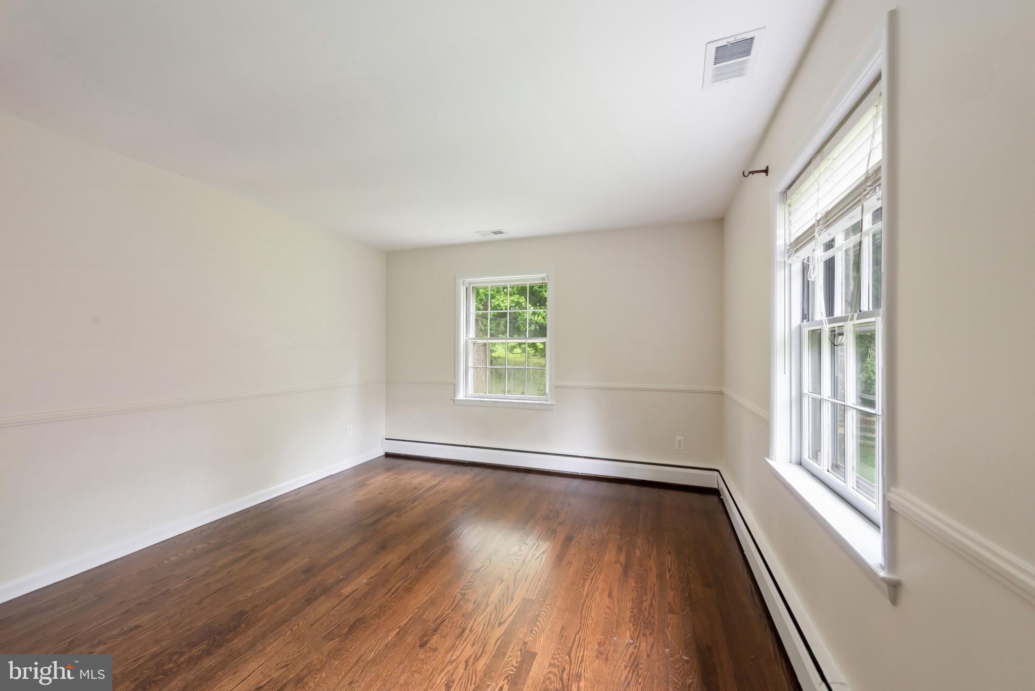 13409 Cambria Farms Road Phoenix, MD 21131 - Photo 29 of 54 an empty room with wooden floor and windows
