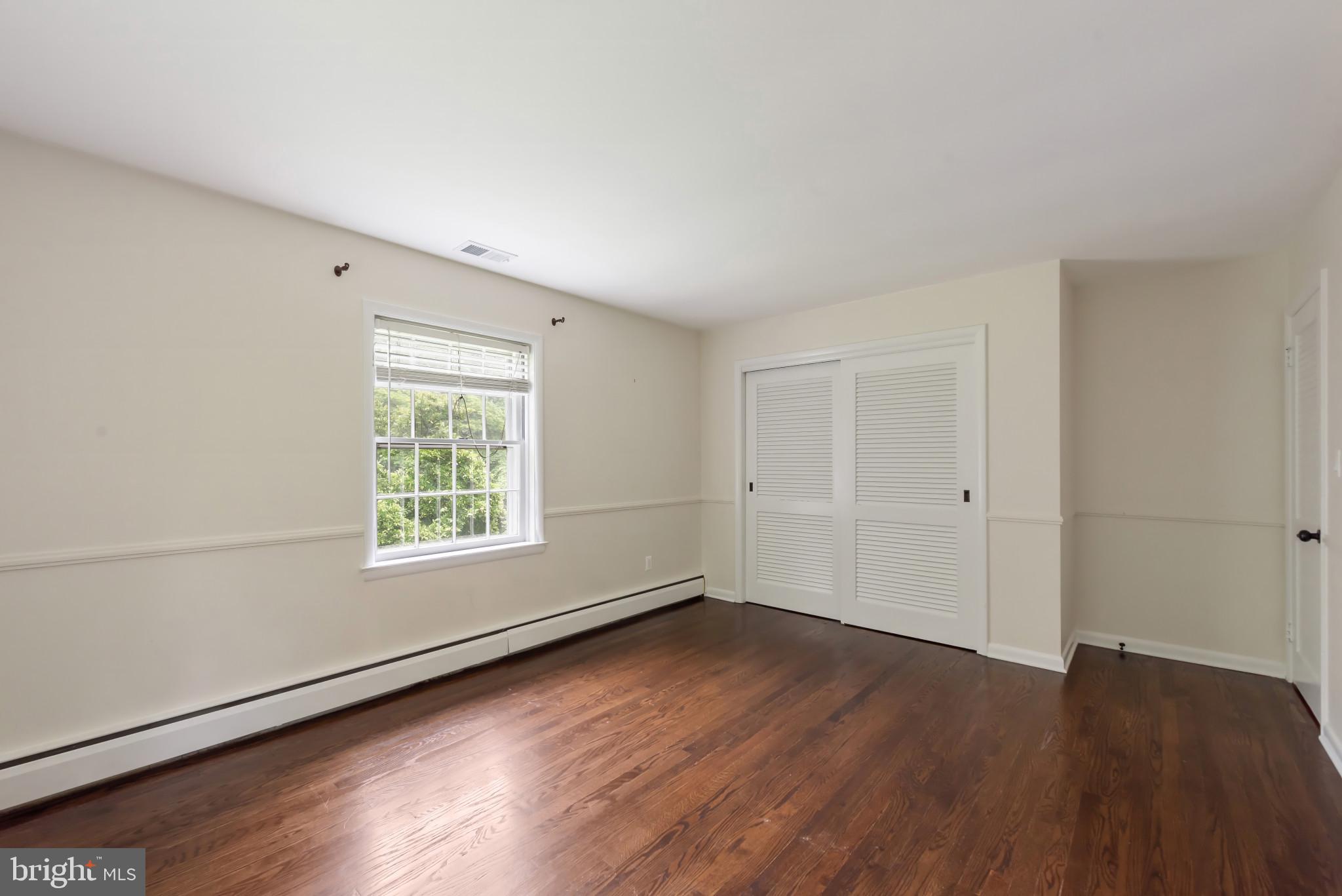 13409 Cambria Farms Road Phoenix, MD 21131 - Photo 30 of 54 an empty room with wooden floor and windows