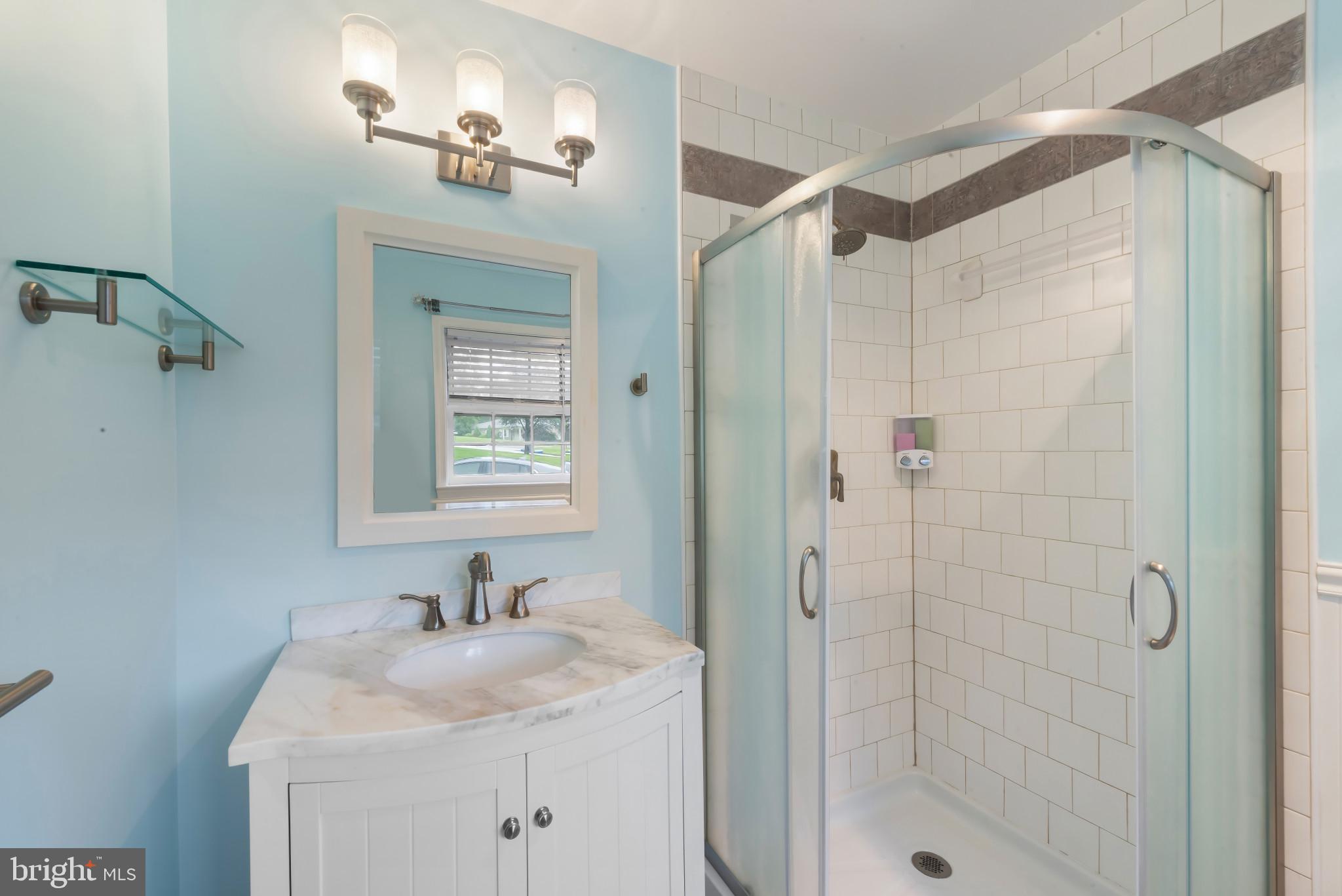 13409 Cambria Farms Road Phoenix, MD 21131 - Photo 33 of 54 a bathroom with a shower sink and mirror