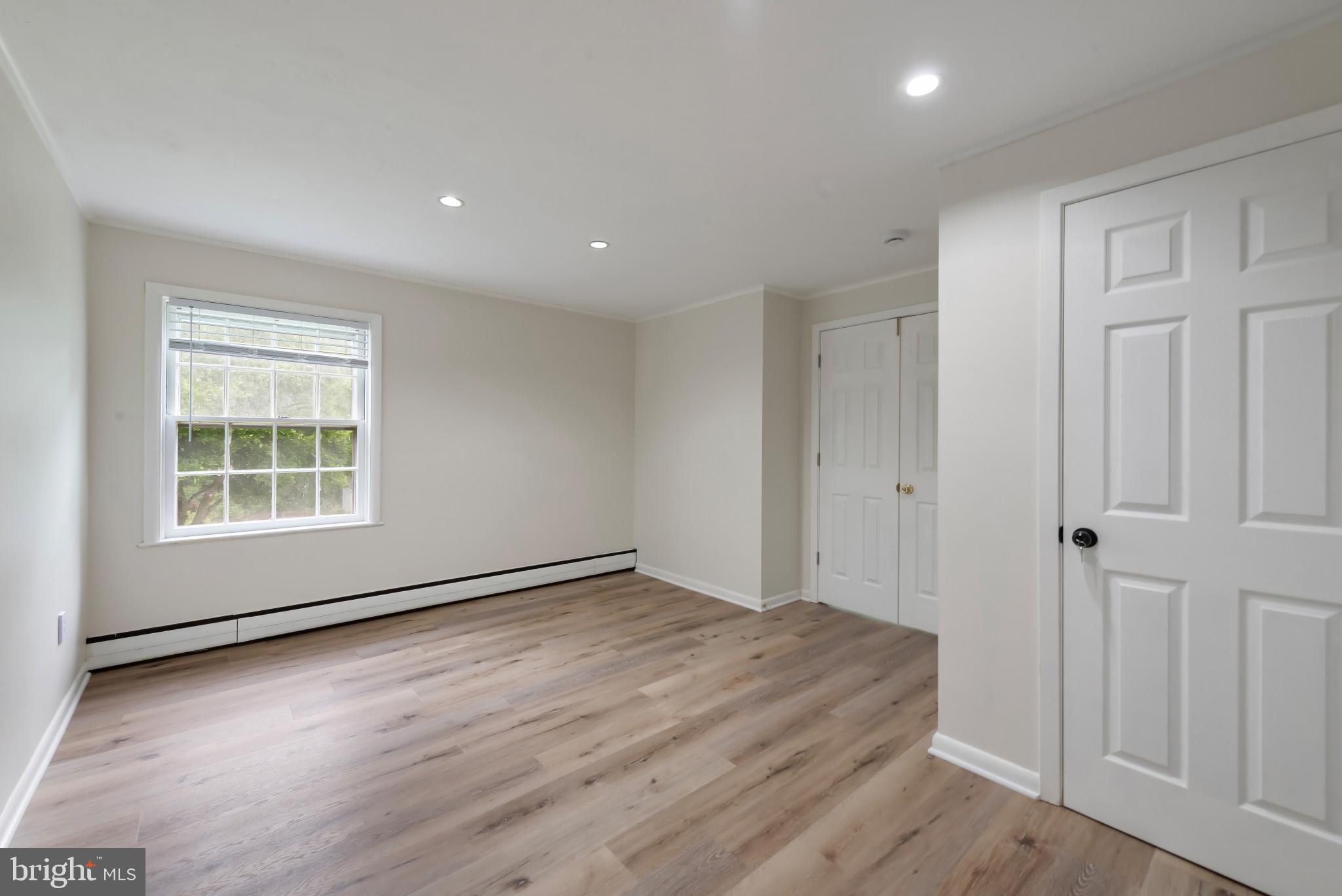 13409 Cambria Farms Road Phoenix, MD 21131 - Photo 35 of 54 an empty room with wooden floor and windows