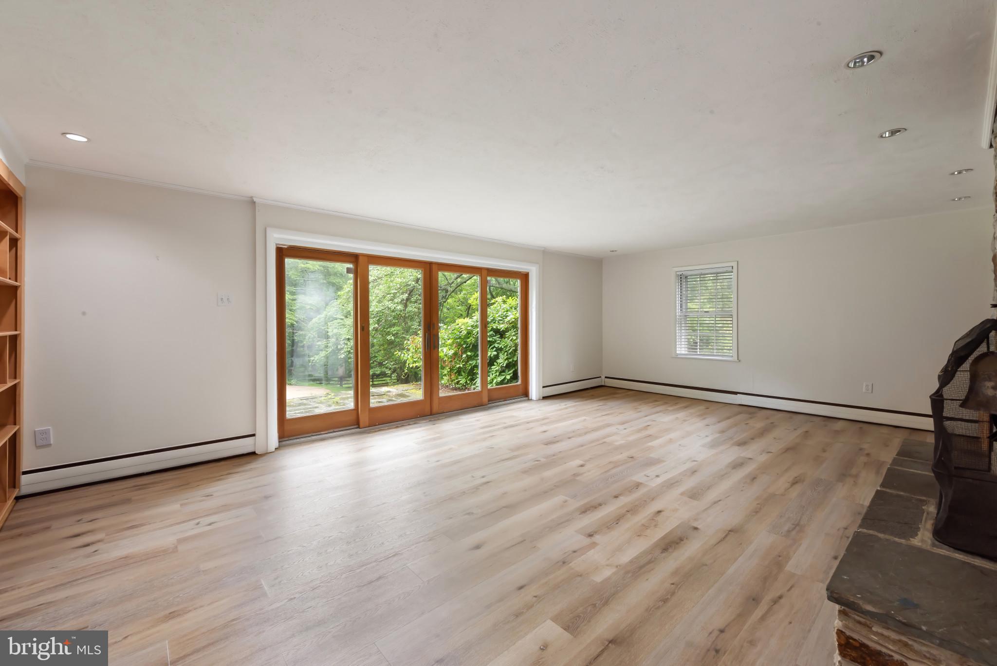 13409 Cambria Farms Road Phoenix, MD 21131 - Photo 36 of 54 an empty room with wooden floor and windows