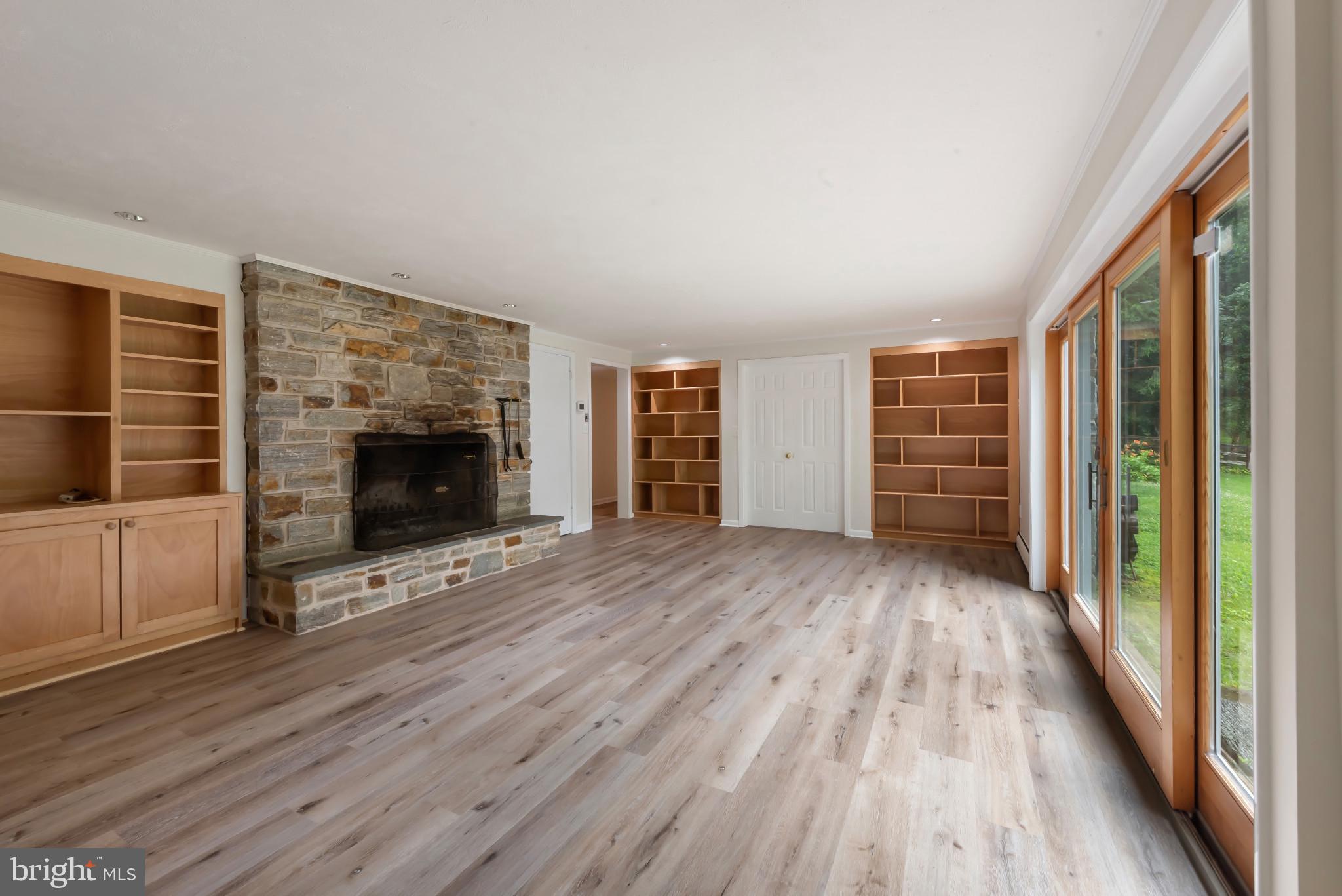 13409 Cambria Farms Road Phoenix, MD 21131 - Photo 38 of 54 wooden floor in an empty room with a fireplace