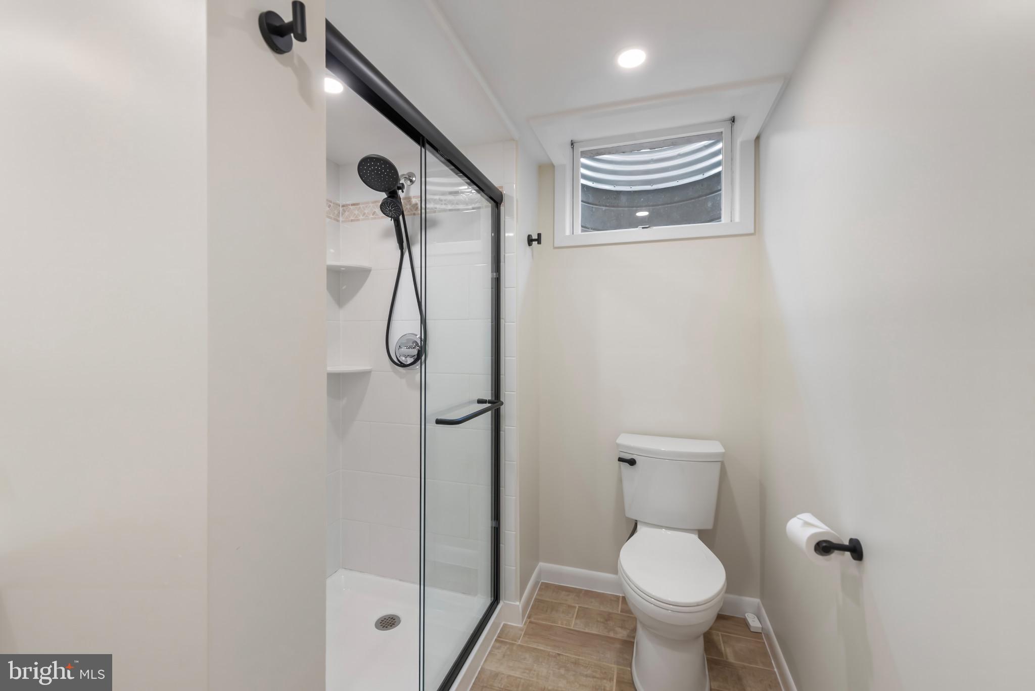 13409 Cambria Farms Road Phoenix, MD 21131 - Photo 39 of 54 a bathroom with a granite countertop toilet and a shower