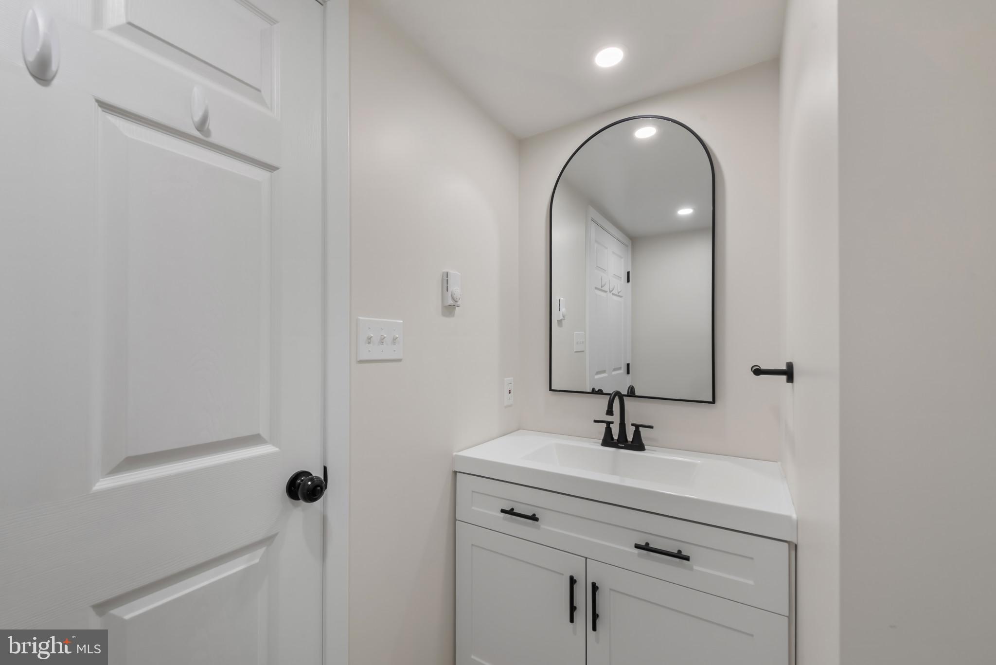 13409 Cambria Farms Road Phoenix, MD 21131 - Photo 40 of 54 a bathroom with a sink a light fixture and a mirror