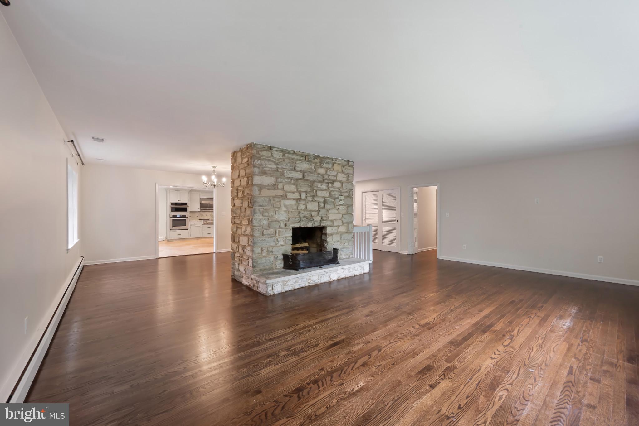 13409 Cambria Farms Road Phoenix, MD 21131 - Photo 8 of 54 a view of empty room with wooden floor and fireplace