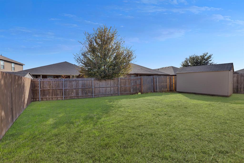 605 Clearbrook Street Azle, TX 76020 - Photo 27 of 33 Expansive grassy yard area with a wood privacy fence