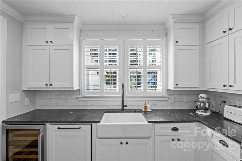 2156 Colony Road Charlotte, NC 28209 - Photo 21 of 46 a kitchen with granite countertop a sink stove and cabinets