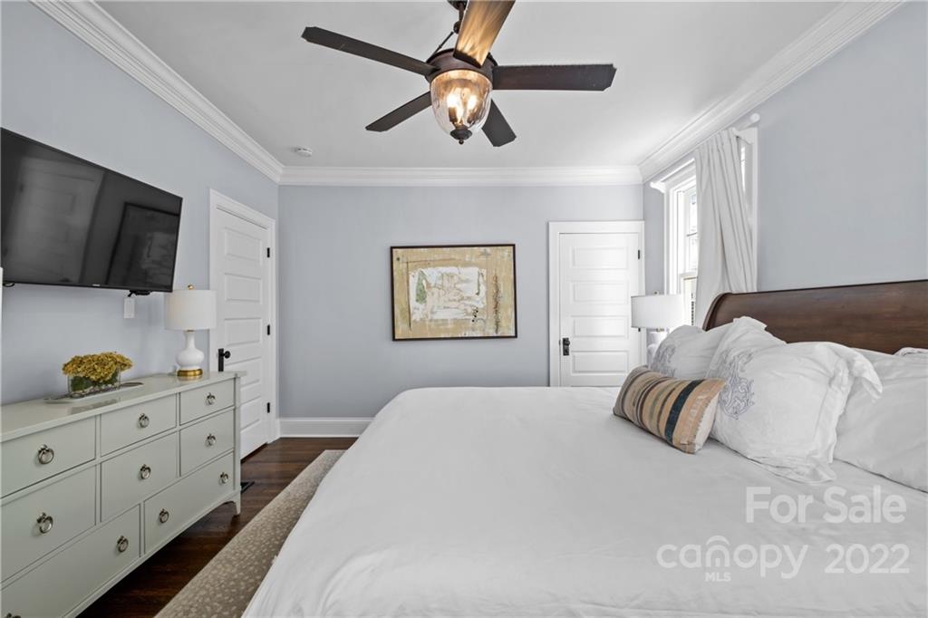 2156 Colony Road Charlotte, NC 28209 - Photo 28 of 46 a bedroom with a bed a window and a flat screen tv